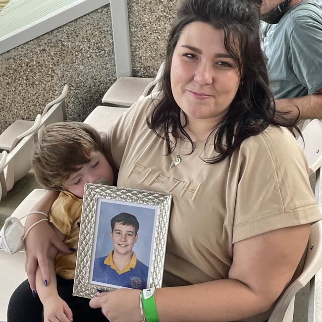 Georgie Gardam at an AFL tribute match with a photo of her son Zane who tragically died during a jumping castle accident at Hillcrest Primary School. Picture: Helen Kempton.