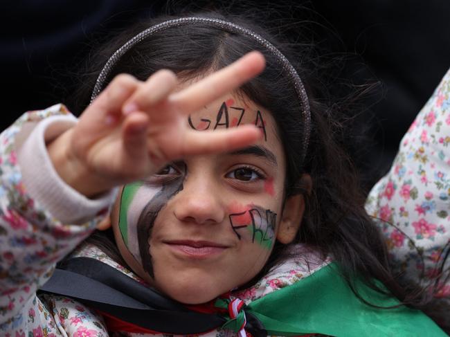 A young girl with a "Free Gaza" message painted on her face gestures during a 'March For Palestine', part of a pro-Palestinian national demonstration, in London. Picture: AFP