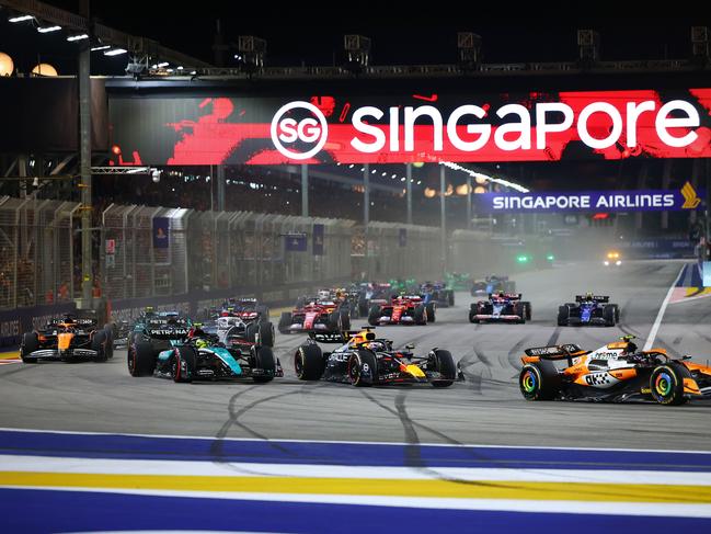 Lando Norris of the United Kingdom and McLaren Formula 1 Team, Max Verstappen of the Netherlands and Red Bull Racing-Honda RBPT, and Lewis Hamilton of the United Kingdom and Mercedes-AMG Petronas F1 Team drive on the opening lap of the F1 Grand Prix of Singapore at Marina Bay Street Circuit in Singapore, Singapore, on September 22, 2024. (Photo by Morgan Hancock/NurPhoto via Getty Images)Escape 2 Feb 2025