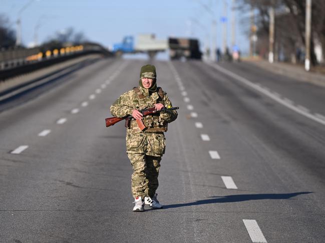 An Ukrainian service member patrol the empty road in the Ukrainian capital of Kyiv. Picture: AFP