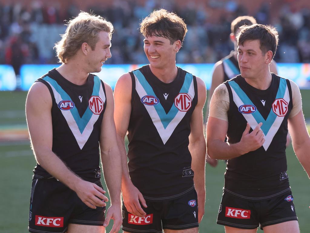 ADELAIDE, AUSTRALIA – JULY 06: Jason Horne-Francis, Connor Rozee and Zak Butters of the Power celebrate their win during the 2024 AFL Round 17 match between the Port Adelaide Power and the Western Bulldogs at Adelaide Oval on July 05, 2024 in Adelaide, Australia. (Photo by James Elsby/AFL Photos via Getty Images)