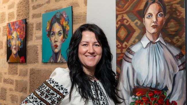 3rd of June 2025  - Ukrainian refugee Yuliya Klymenko with her artwork at exhibition Colours of Ukraine in the Prospect Library. Yuliya and her two children arrived in Adelaide in 2022 after fleeing Ukraine and have since been joined by her husband. Photo: Naomi Jellicoe