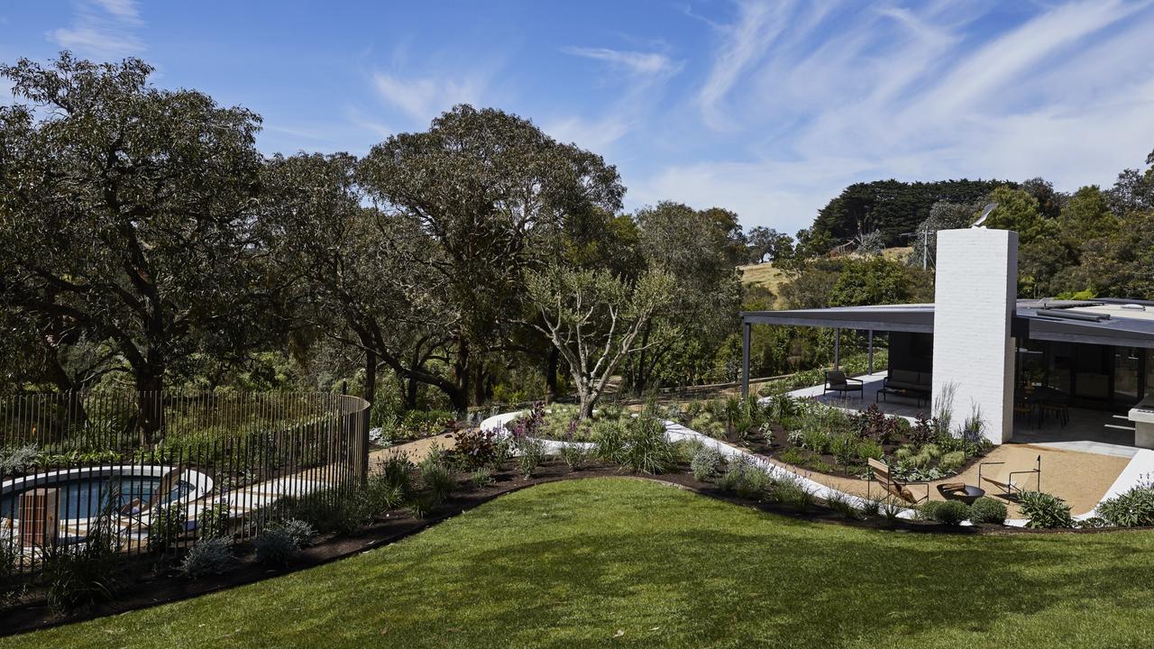 The lush backyard has a pool and plenty of space for entertaining.