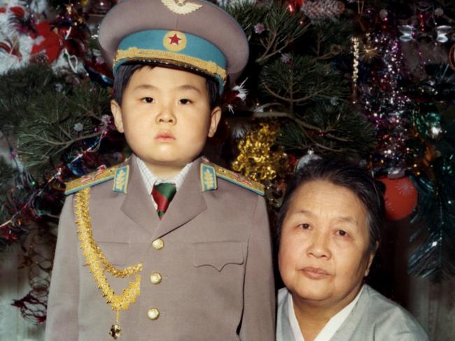 Kim Jong-nam dressed in an army uniform poses with his maternal grandmother in January 1975. Picture: AFP