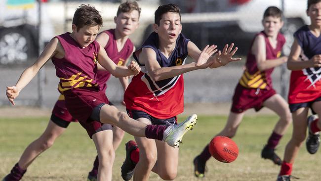 day three of the School Sport SA Sapsasa Country Football Carnival - Year 7 Division 1: Upper South East (red/blue) v Gawler (maroon) at West Beach , 2 June 2021. Picture Simon Cross