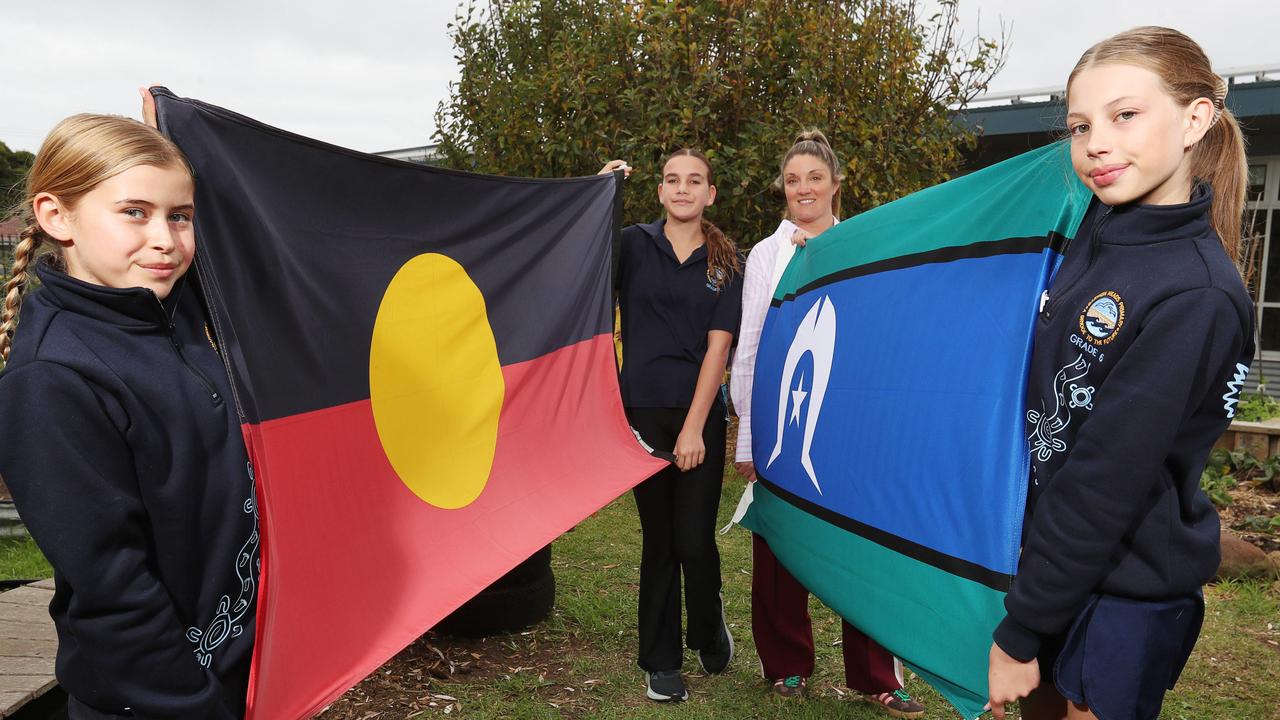 Barwon Heads students Hazel, Mayah and Indigo with teacher Katie Geering. BH Primary School celebrated Reconcilliation week bu creating a human flag over the Barwon Heads Bridge. Picture: Alan Barber