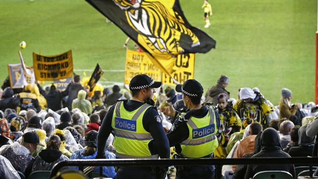 Officers patrol the aisles for trouble during the Richmond and Collingwood clash. Picture: David Caird