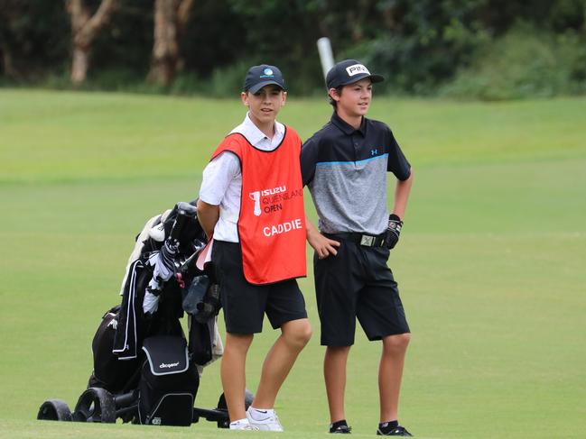 Surfers Paradise Golf Club's Bill Dowling, just 15, and his even younger caddie Alfie Ward, 13, team up for their day out at the Isuzu Queensland Open at Pelican Waters on Thursday. Photo: Kirsty Wrice, Golf Australia