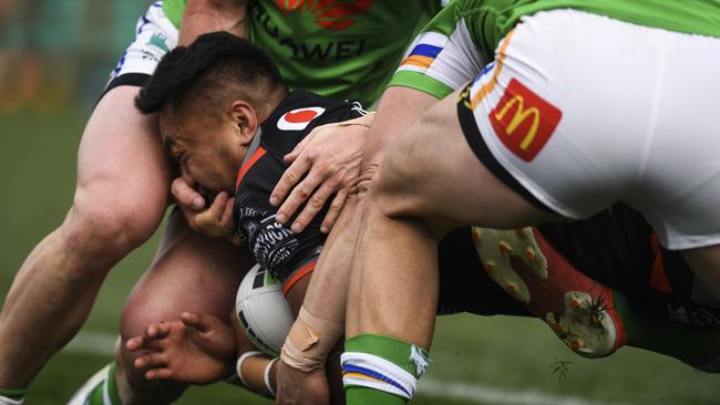 Hudson Young with his hand in the face of Adam Pompey. Picture: AAP