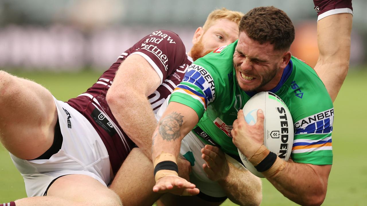 Raiders forward Adam Elliott is tackled by Brad Parker at Central Coast Stadium. Picture: Ashley Feder/Getty Images