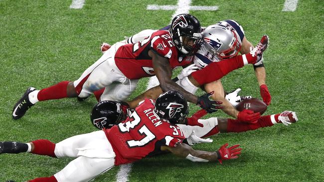 New England’s Julian Edelman makes a miracle catch in the fourth quarter against Ricardo Allen, Robert Alford and Keanu Neal of the Atlanta Falcons during Super Bowl LI