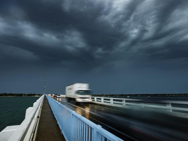 A storm cell passes over the bridge to Bribe Island as wild weather lashes southeast Queensland. Picture: Lachie Millard