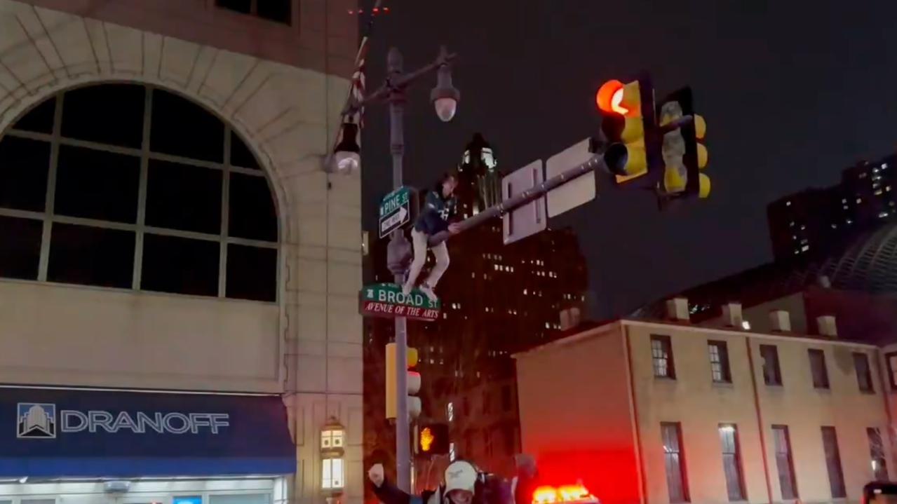 An eager fan climbs up onto the lights. Photo/X