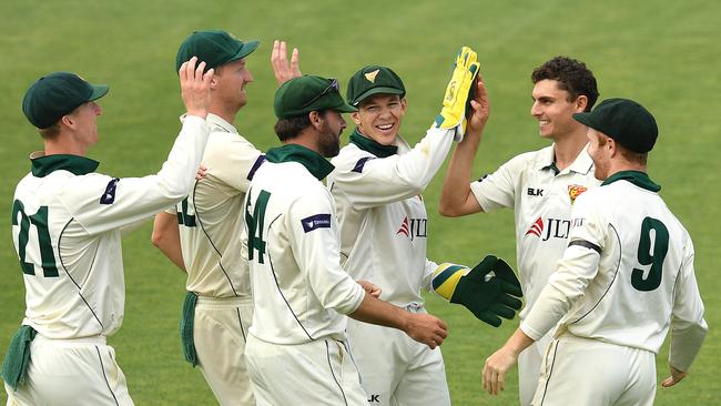 Tasmanian bowler Simon Milenko, second from right, celebrates after snaring a wicket. Picture: AAP/Dave Hunt