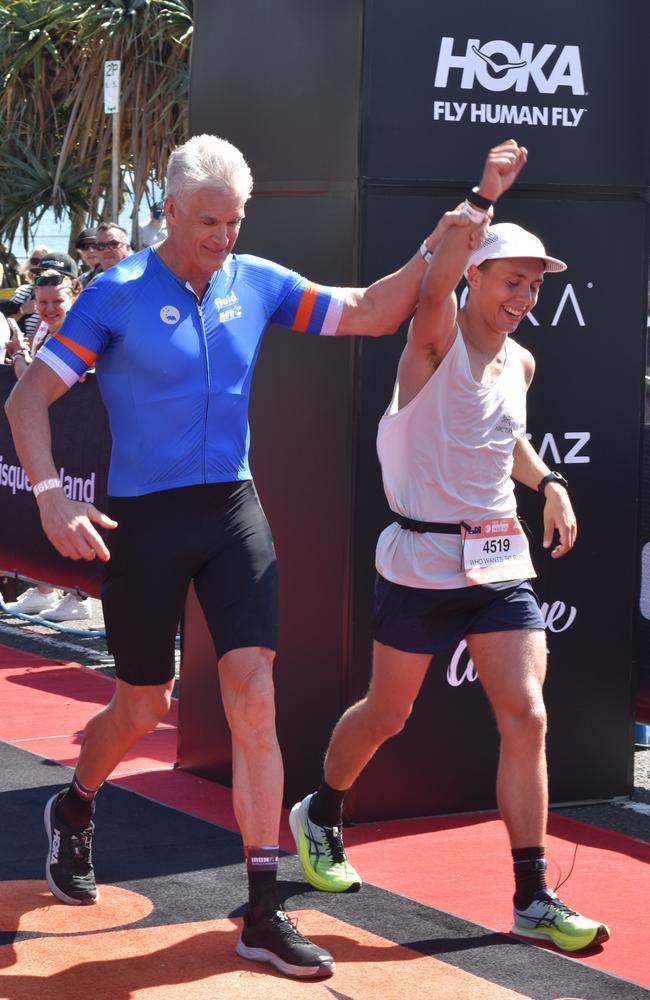 Athletes crossing the finish line at Sunshine Coast Ironman 70.3 2023.