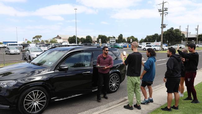 Fans have items signed by Katy Perry while she sits in her car after landing into Melbourne Picture: Brendan Beckett