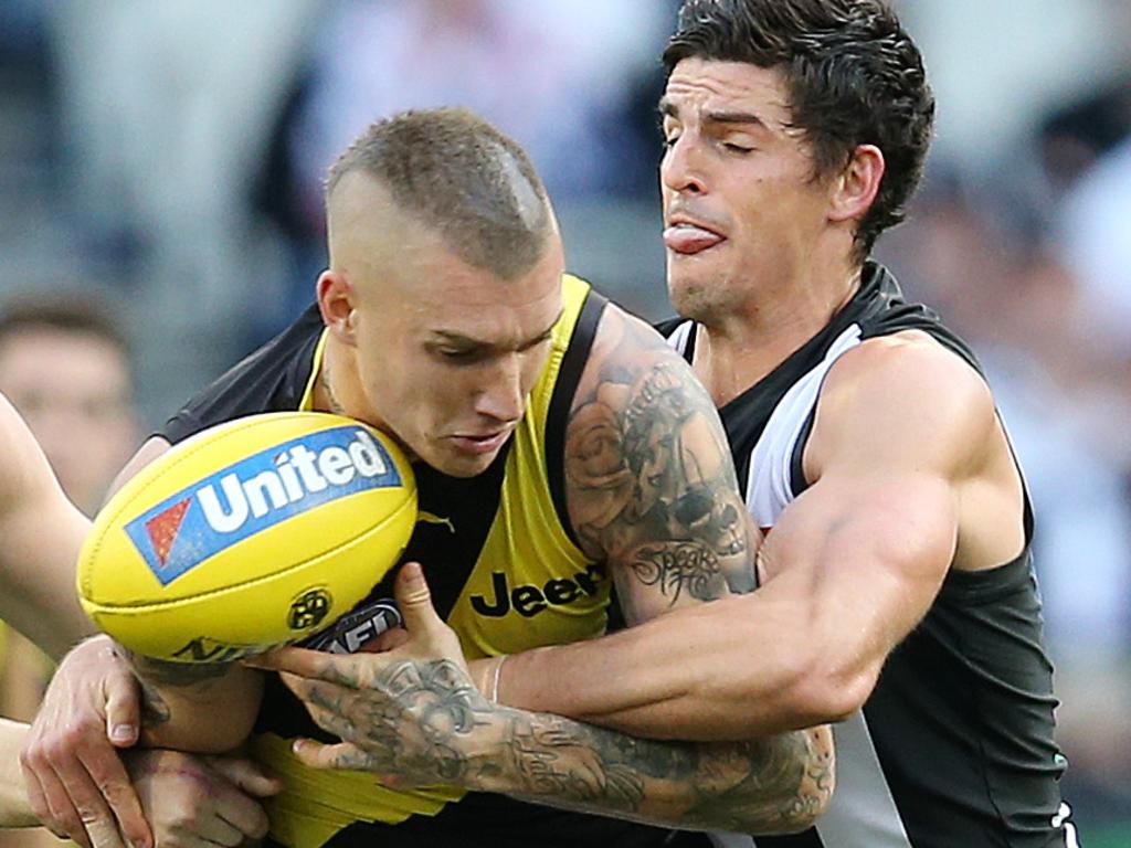 AFL Round 6. 29/04/2018. Collingwood v Richmond at the MCG.  Richmond's Dustin Martin caught by Collingwood's Scott Pendlebury and Collingwood's Jordan De Goey  . Pic: Michael Klein