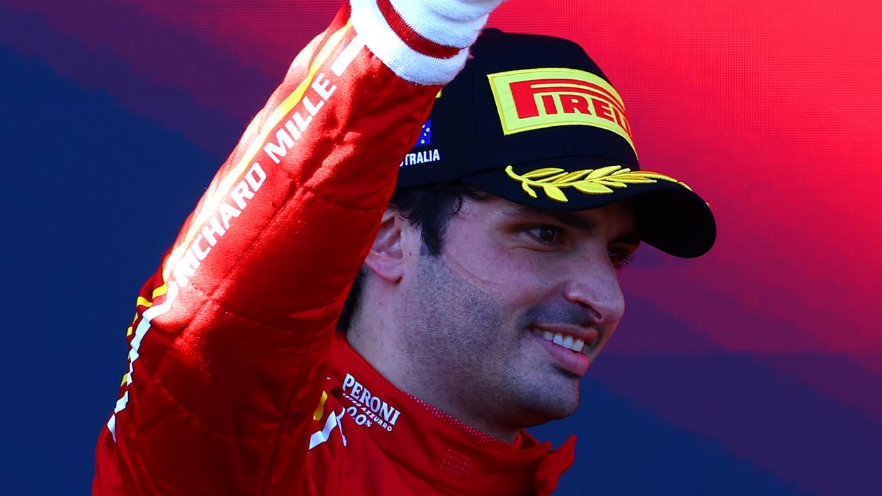 MELBOURNE, AUSTRALIA - MARCH 24: Race winner Carlos Sainz of Spain and Ferrari celebrates on the podium during the F1 Grand Prix of Australia at Albert Park Circuit on March 24, 2024 in Melbourne, Australia. (Photo by Mark Thompson/Getty Images)