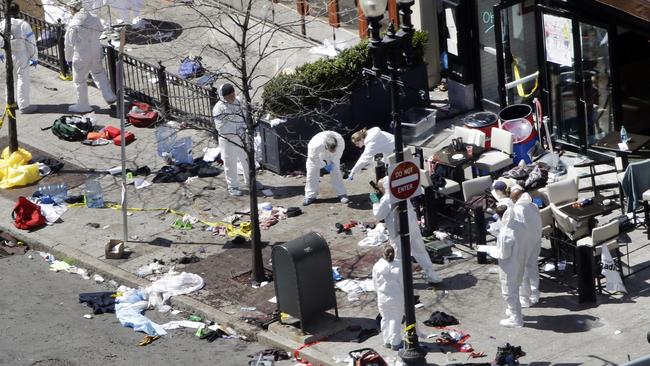 Investigators examine the scene of the second bombing in Boston on April 15, 2013. Picture: AP Photo