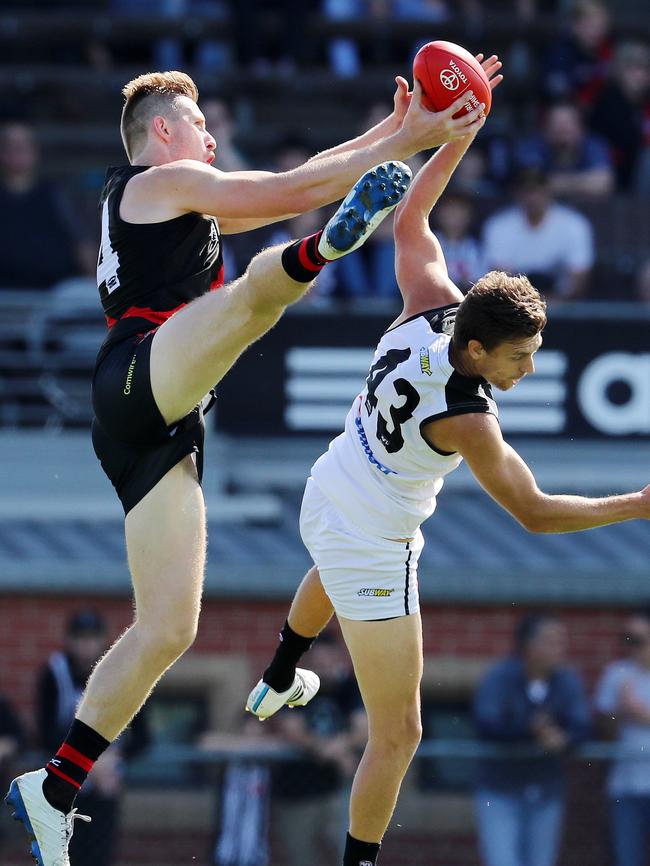 Essendon’s Shaun McKernan completes an acrobatic mark over Adam Oxley on Saturday. Pic: Michael Klein.