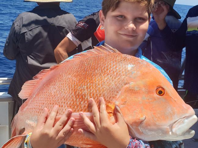 Jack Rushton shows off a hefty red emperor caught while fishing with Northern Conquest Charters.