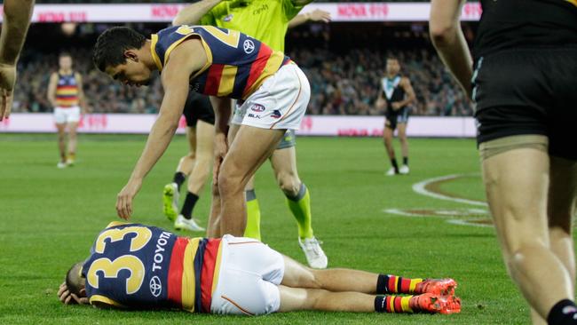 Charlie Cameron checks on his Adelaide teammate Brodie Smith.