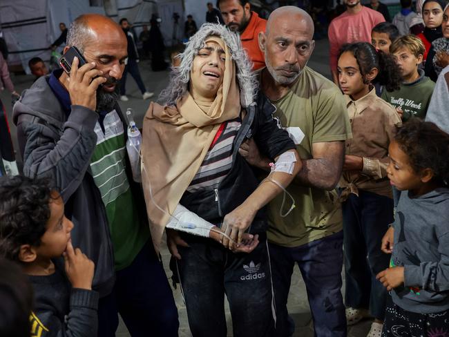 A wounded person is helped into the al-Aqsa Martyrs Hospital in Deir Al-Balah in the central Gaza Strip. Picture: AFP