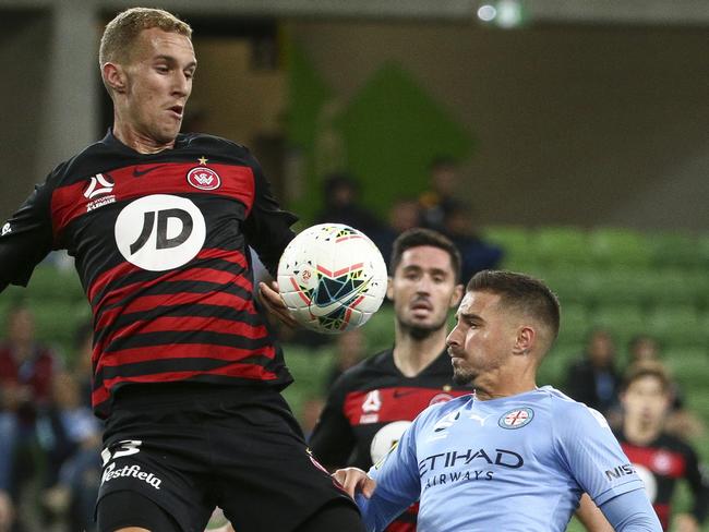 MELBOURNE, AUSTRALIA - MARCH 14: Tass Mourdoukoutas of Western Sydney Wanderers and Jamie Maclaren of Melbourne City compete for the ball during the round 23 A-League match between Melbourne City and the Western Sydney Wanderers at AAMI Park on March 14, 2020 in Melbourne, Australia. (Photo by Luke Hemer/Getty Images)