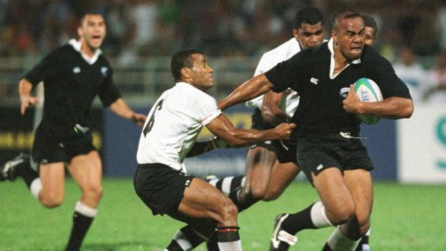 Jonah Lomu fends off Fiji's Serevi Waisale as he makes a break during the 1998 Commonwealth Games Rugby Sevens Final. Picture: Getty Images