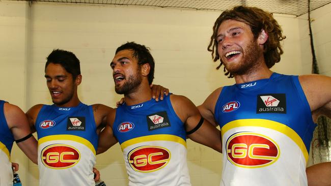 Hunt celebrates Gold Coast’s win over GWS with Aaron Hall and Jack Hutchins in 2013.