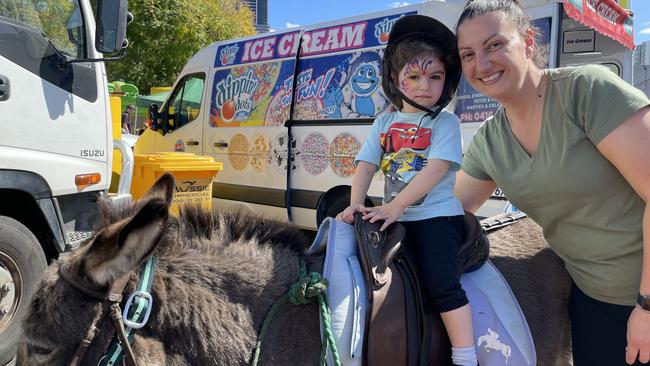 Belinda Saba with her daughter Jessica, 2, who enjoys a donkey ride at the Let's Go Greek Festival in the grounds of St Ioannis Greek Orthodox Church at Parramatta.