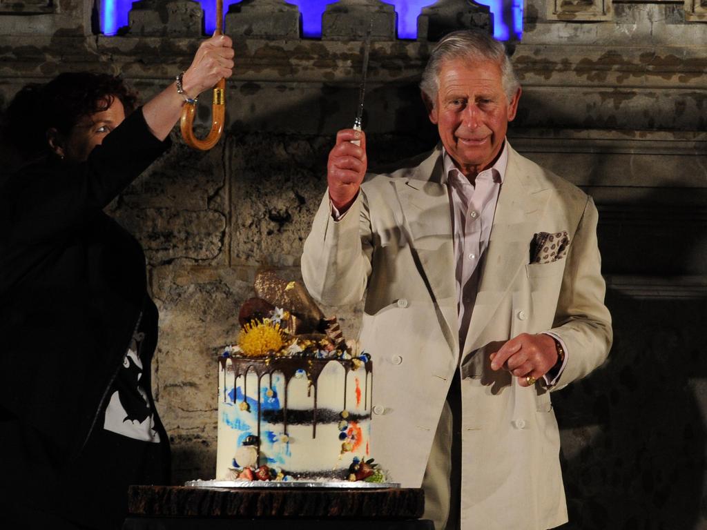 Britain's Prince Charles cuts a birthday cake during a visit to News  Photo - Getty Images