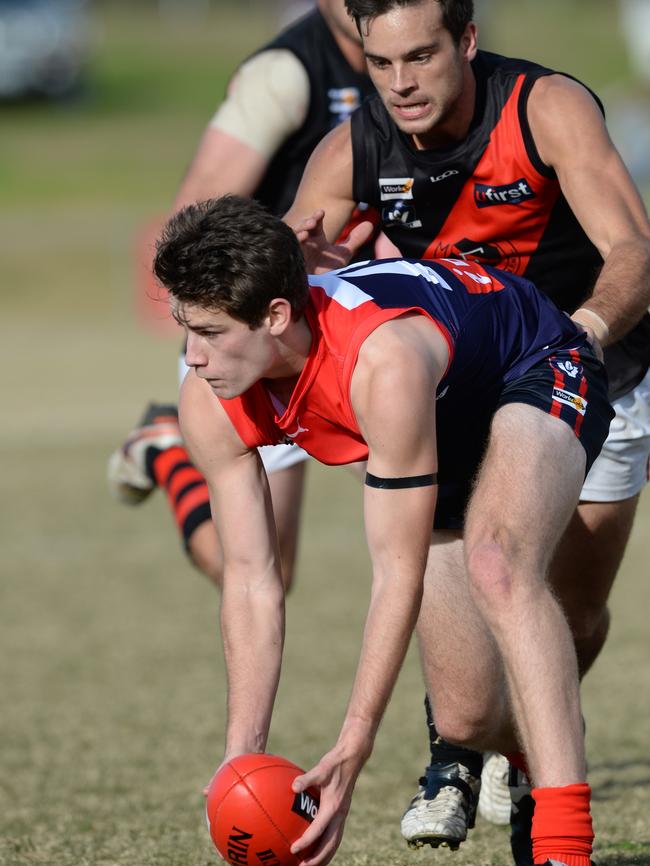 Mt Eliza’s Sam Mourney wins ball ahead of Bomber Sam Fox.