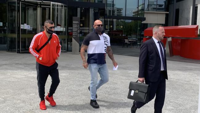 Ali Hassan Bilal (centre) leaves the ACT Law Courts with Lawyer Peter Woodhouse (right, in suit) and an associate (left, in red shirt) Picture:Julia Kanapathippillai