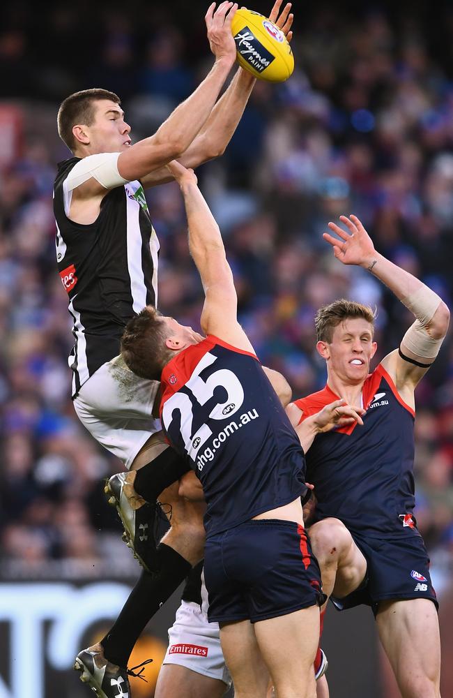 Mason Cox flies for a mark over Tom McDonald. Picture: Getty