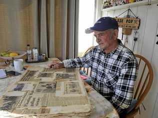 Jockey Paul Alderman, who rode Floating High to victory in the Ramornie Handicap in 1974, looks at one of his scrapbooks of old newspaper clippings. Picture: Tim Jefferies