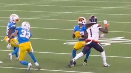 The Chargers’ punt returner Derius Davis was hit before catching the ball.