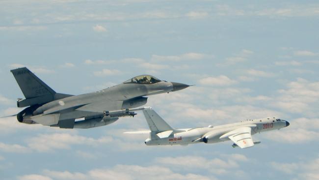 A Republic of China (Taiwan) Air Force F-16 fighter aircraft, left, flies alongside a Chinese People's Liberation Army Air Force (PLAAF) H-6K bomber. Picture: AFP