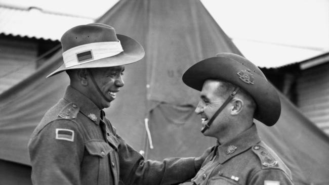 Lieutenant Reg Saunders (left) and Lieutenant Tom Derrick VC DCM, congratulate each other following their graduation from the Office Cadet Training Unit at Seymour. Picture: Reproduced courtesy of the Australian War Memorial