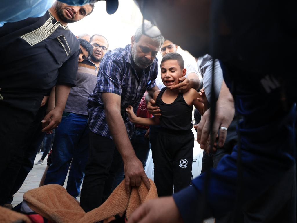 A young boy reacts upon recognising the bodies of his father and younger sister, Misq and Mohammed Joudeh, killed in an Israeli strike, in front of the morgue of the Al-Aqsa hospital in Deir Balah in the central Gaza Strip. Picture: AFP