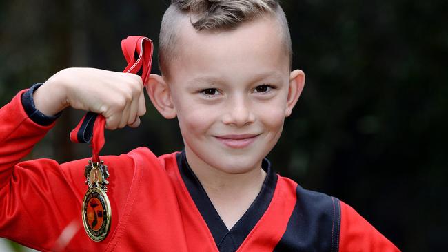 Mitchell with his Anzac Day footy medal. Picture: Steve Tanner