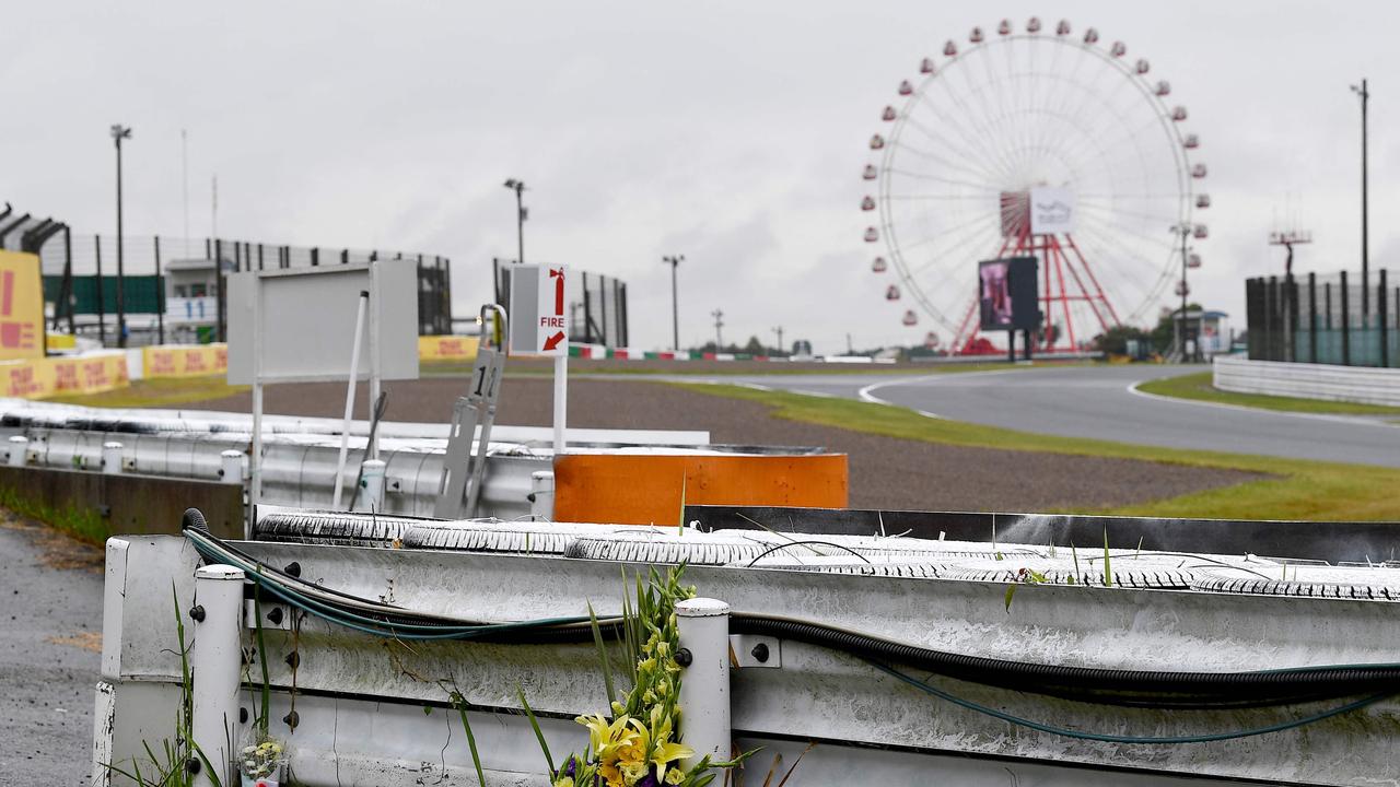 A bouquet of flowers sits at the site where French driver Jules Bianchi crashed in October 2014 suffering fatal injuries, ahead of the first practice session for the Formula One Japanese Grand Prix at Suzuka, Mie prefecture on October 7, 2022. – Bianchi died in 2015 from head injuries sustained in the crash at the 2014 Japanese Grand Prix nine months earlier. (Photo by Toshifumi KITAMURA / AFP)