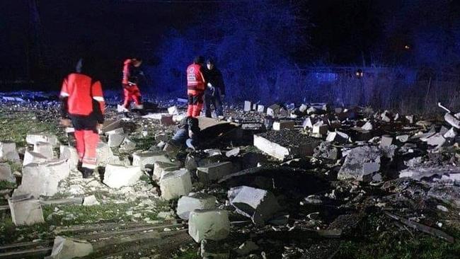 Frontline workers inspect the damage. Picture: Reuters