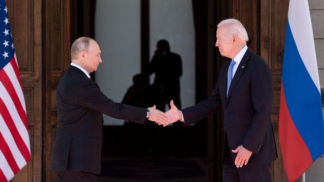 Vladimir Putin and Joe Biden shake hands ahead of their meeting in Geneva. Picture: Brendan Smialowski/AFP