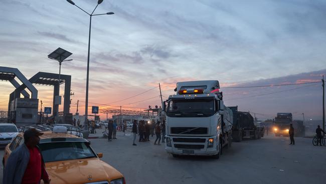 Trucks carrying humanitarian aid enter the Gaza Strip via the Rafah crossing with Egypt on the second day of a truce between Israel and Hamas. Picture: AFP