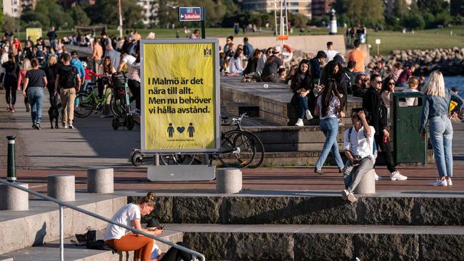 People enjoy the warm evening in Malmo, Sweden, where social restrictions aren’t as heavy-handed as elsewhere in the world. Picture: AFP