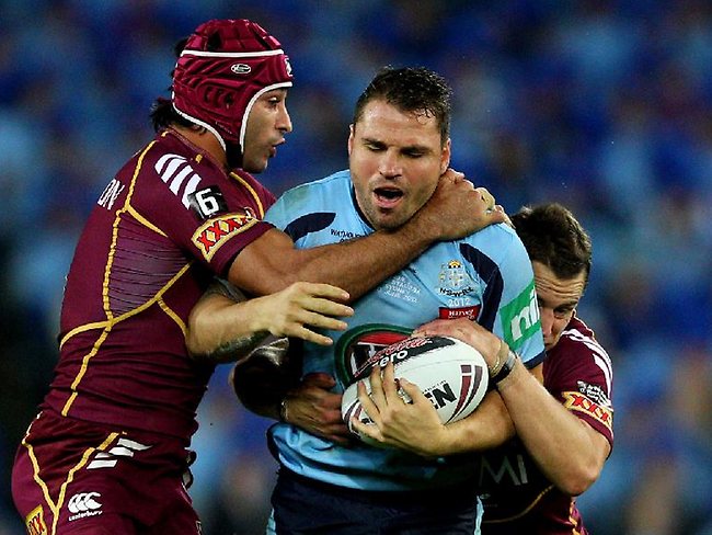 State of Origin II, 2012: Johnathan Thurston and Ashley Harrison tackle NSW forward Anthony Watmough. Picture: Brett Costello