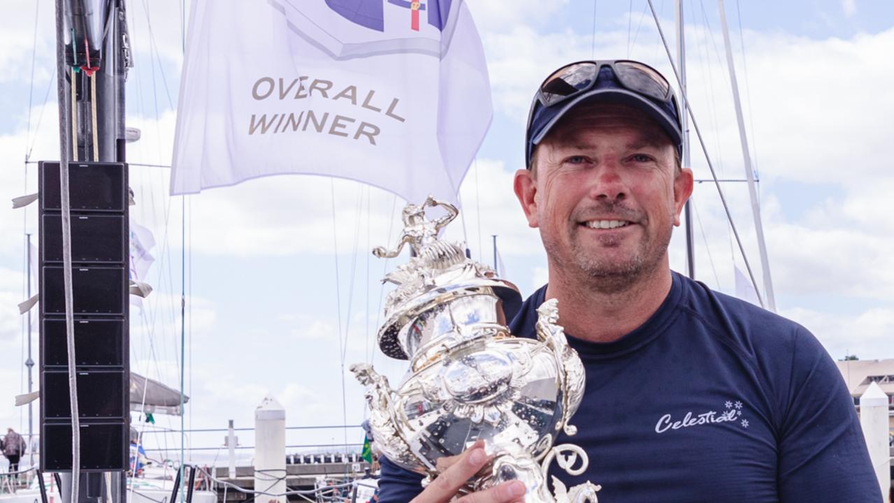 Celestial crewmen Troy Grafton on board Celestial with the Tattersalls Cup. Pi: Linda Higginson