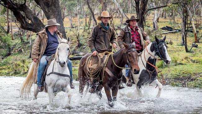 Phil Maguire, Lewis Benedetti and Charles Connley prepare to ride out to rein in the wild brumbies. Picture: Jake Nowakowski
