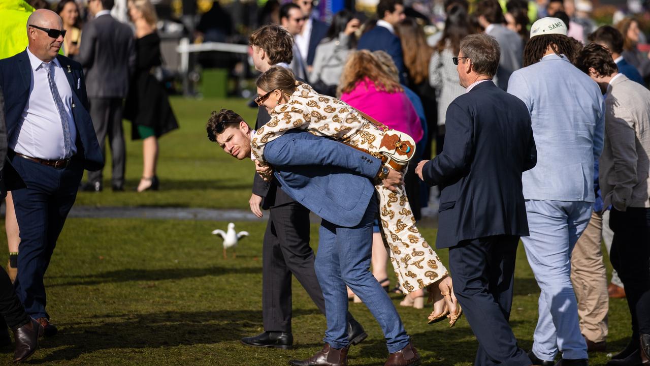 Racegoers are hit with rain, hail and shine. Picture: Jason Edwards